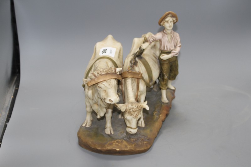 A Royal Dux group of a boy and two oxen, length 37cm